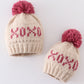 Cream XOXO knit beanie pom pom hat