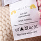 Cream XOXO knit beanie pom pom hat