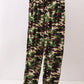 Camouflage pants on a hanger against a white background