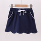 Navy scallop hem bow skort