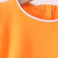 Orange flutter sleeve scalloped top