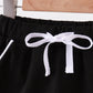 Black scallop hem bow skort