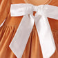 Gold velvet bow dress