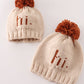 Beige pompom hi cable beanie hat