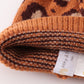 Brown pompom leopard cable beanie hat